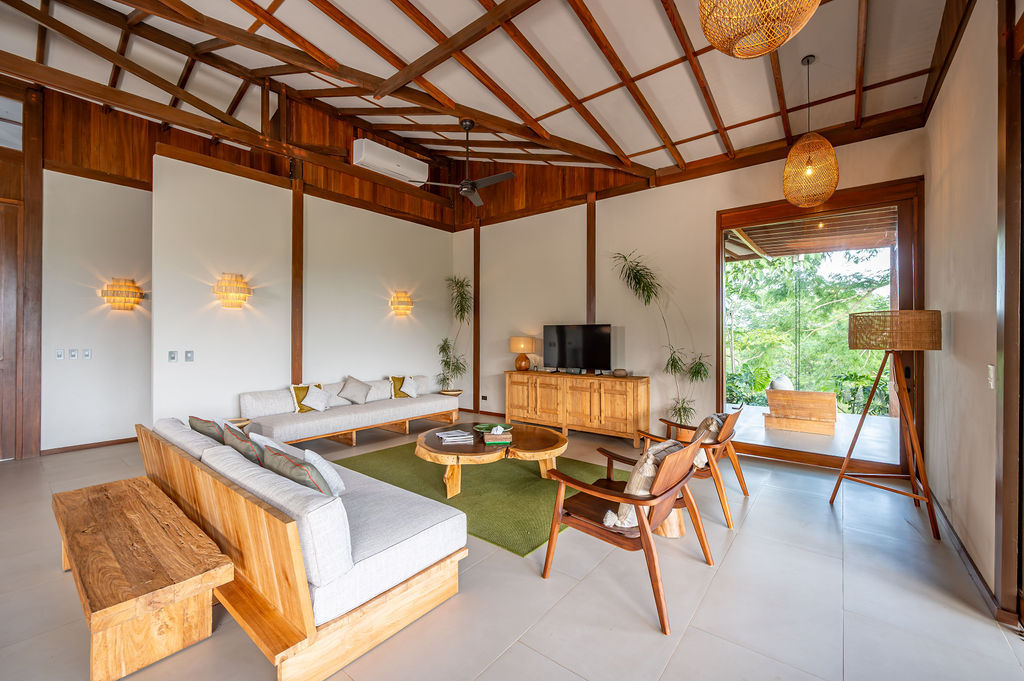 Vaulted living room with timber rafters and full-height glass doors