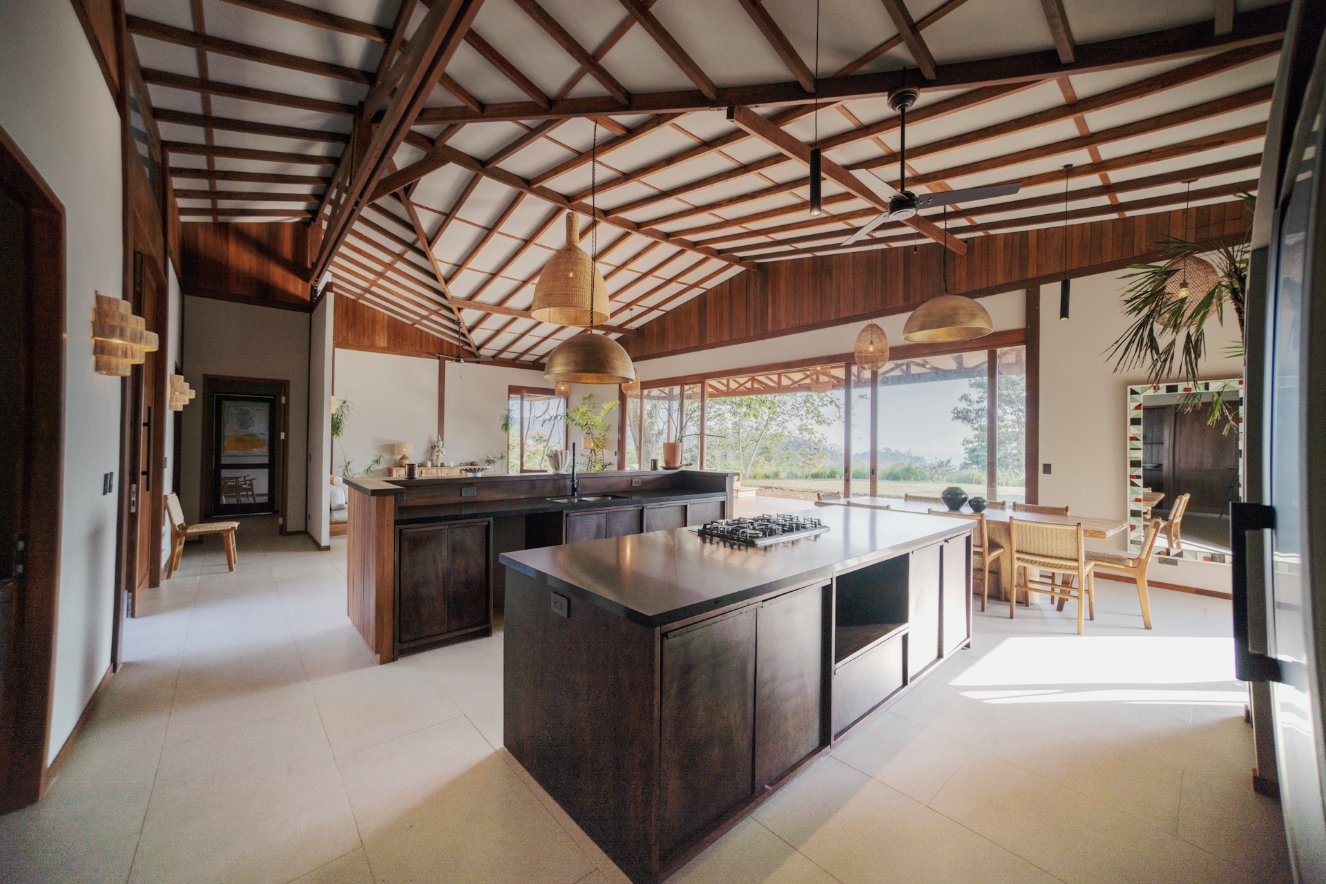 Open kitchen with twin islands, brass pendants, and the valley beyond